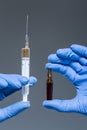 Close up of hands holding drug and syringe