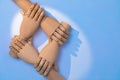 Close up of hands holding each other. Two pairs of wooden prosthetic hands are staggered to build a cooperative appearance. A comb Royalty Free Stock Photo
