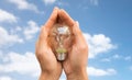 Close up of hands holding edison lamp or lightbulb Royalty Free Stock Photo