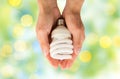 Close up of hands holding energy saving lightbulb Royalty Free Stock Photo