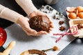 close up of hands holding gingerbread dough