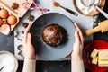 close up of hands holding gingerbread dough