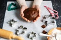 close up of hands holding gingerbread dough