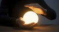 Hands Holding Illuminated Crystal Ball, Foretelling Future Royalty Free Stock Photo