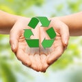Close up of hands holding green recycling sign Royalty Free Stock Photo