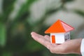 Close up of hands holding house model, building, mortgage, real estate and property concept Royalty Free Stock Photo