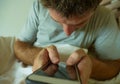 Close up hands holding mobile phone of young man at home bedroom using internet social media app on smartphone networking and text Royalty Free Stock Photo