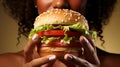 Close up of hands holding mouthwatering burger, about to be devoured with anticipation