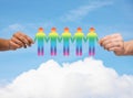 Close up of hands holding paper chain gay people Royalty Free Stock Photo