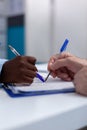 Close up of hands holding pen on document files Royalty Free Stock Photo