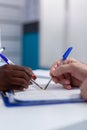 Close up of hands holding pen on document files Royalty Free Stock Photo