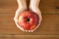 Close up of hands holding ripe red apple Royalty Free Stock Photo