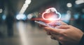 Hands holding smartphone with glowing cloud icon symbolizing cloud computing Royalty Free Stock Photo