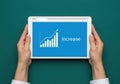 Hands holding tablet showing upward trend graph and word \'increase\' for business growth and success Royalty Free Stock Photo