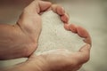 Close up hands holding white sand heart shape Royalty Free Stock Photo