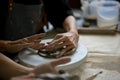 Close-up hands image, A man molding or sculpting raw clay on a small pottery wheel Royalty Free Stock Photo