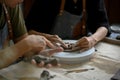Close-up hands image, A man molding or sculpting raw clay in a workshop with his friend Royalty Free Stock Photo