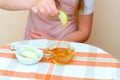 Close up of hands jewish child dipping apple slices into honey on Rosh Hashana. Royalty Free Stock Photo