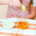 Close up of hands jewish child dipping apple slices into honey on Rosh Hashanah. Royalty Free Stock Photo