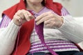 Close-up on hands of knitting senior woman