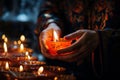 Close-up of hands lighting candles and incense in an Orthodox home, marking the New Year with traditional customs and prayers,