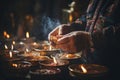 Close-up of hands lighting candles and incense in an Orthodox home, marking the New Year with traditional customs and prayers,