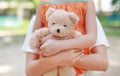 Close-up hands of little child girl and mom hugging teddy bear. Mother and daughter cuddle doll Royalty Free Stock Photo