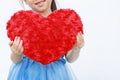 Close-up hands of little girl holding a red heart pillow isolated on white background Royalty Free Stock Photo