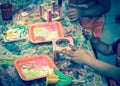 Kid hands painting craft at building workshop in local hardware store in Texas, USA