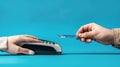Close-up of hands making a contactless payment with a credit card on a blue background emphasizing modern technology and Royalty Free Stock Photo