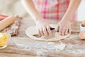 Close up of hands making cookies from fresh dough