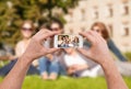 Close up of hands making picture of group of teens Royalty Free Stock Photo