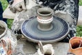 Close-up of hands making pottery from clay on a wheel.