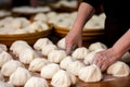 close-up of hands making traditional dumplings in kitchen preparation