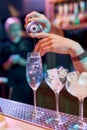 Close up of hands of male bartender pouring, mixing ingredients while making classic cocktail alcoholic drink at the bar Royalty Free Stock Photo