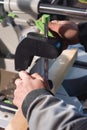 Close-up of the hands of a male carpenter set the workpiece in the clamps of a circular machine. Handwork. Starting a Royalty Free Stock Photo