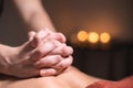 Close-up of the hands of a male masseur doing back massage to a girl at the spa. Low key high contrast shallow depth of Royalty Free Stock Photo