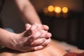 Close-up of the hands of a male masseur doing back massage to a girl at the spa. Low key high contrast shallow depth of Royalty Free Stock Photo