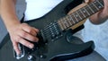Close up. hands of a male musician playing an electric guitar with a pick Royalty Free Stock Photo