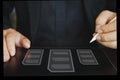 Close up a hands man in a black suit writing an electronic signature by application on a tablet Royalty Free Stock Photo