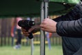 Close up of hands of man fastening metal frame stand to trampoline support using cordless screwdriver to set on yard. Royalty Free Stock Photo