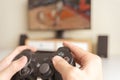 Close up hands of man, gamer using gaming controller or game pad when play video console game or online computer game at home. Royalty Free Stock Photo