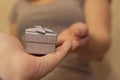 Close Up on hands man giving a small gray gift box to woman for Birthday, Christmas and New year, wedding, Valentines day Royalty Free Stock Photo