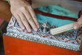 Close up hands man using a brass brush for polishing an old red and golden altar table cracked before repair Royalty Free Stock Photo