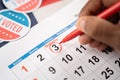 Close up of Hands marking november 3 election day on Calendar as reminder for voting - Concept of reminder for US election