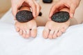 Feet massage by hot stones