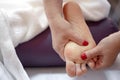 Close-up of hands of masseur doing massage of female feet Royalty Free Stock Photo