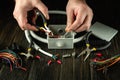 Close-up of the hands of a master electrician during work. Cutting a red wire in a gray junction box. Idea for installation and Royalty Free Stock Photo