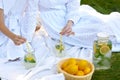 close up hands of mother and daughter drink refresh lemonade picnic on green grass in summer Royalty Free Stock Photo