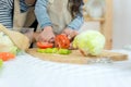 Close up hands mother and kid girl cooking and cutting vegetables on kitchen. Royalty Free Stock Photo